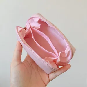 Macro detail view of pink mini canvas storage pouch showing the functional interior divider