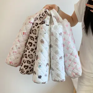 Macro view of various quilted hair dryer storage bags featuring leopard and bear prints