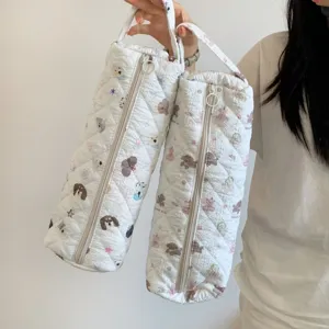 Detail of quilted storage bags with cartoon prints for hair dryers and curling irons