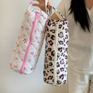 Large quilted storage bags for hair dryers and curling irons with leopard and cherry prints.