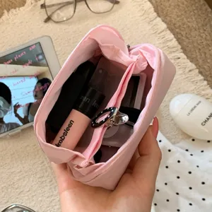Internal compartments of pink mini cosmetic pouch for lipstick and small items