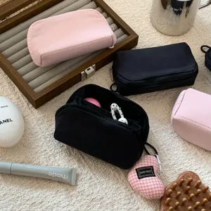 Close-up of portable mini cosmetic pouches with functional inner compartments for small items