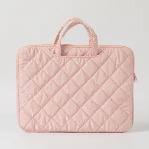 Macro view of the pink quilted laptop bag showing delicate diamond stitching and texture