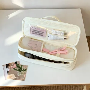 Internal detail view of double-layer hair dryer storage bag with partitions