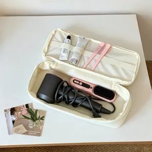 Detailed view of the double-layer hair dryer storage bag with internal compartments.