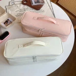 Macro view of double-layer portable hair dryer storage bags in pink and cream