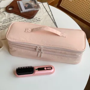 Pink double-layer storage bag for hair dryer and electric styling brush shown on table
