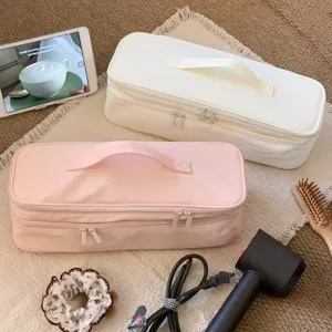 Large capacity double-layer hair dryer storage bag shown in a cozy home setting