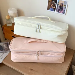 Detail view of large double-layer storage bags in cream and pink colors.