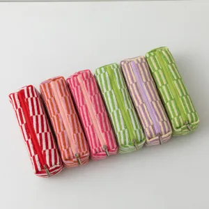 Collection of colorful knitted pencil cases featuring vibrant striped and checkered patterns.