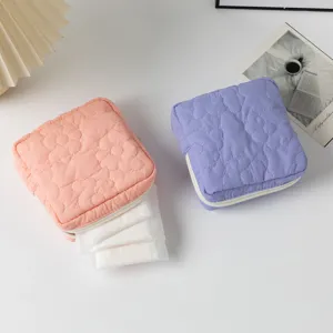 Close-up of quilted floral sanitary napkin bags in candy pink and purple colors