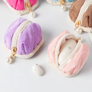 Macro detail of quilted mini tent storage pouch perfectly holding wireless earbuds