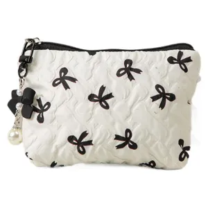 White quilted cosmetic bag featuring black bow patterns and elegant pearl charm attachment