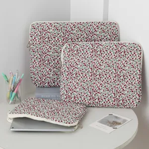 Three sizes of quilted floral laptop and tablet sleeves with metal ring zippers.