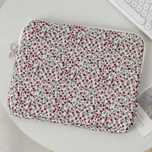 Close-up of a stylish floral quilted laptop sleeve with a beautiful red flower print.