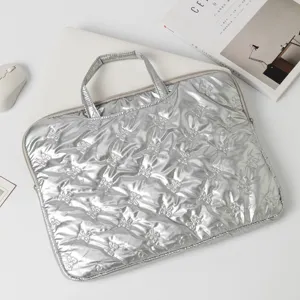 Macro view of quilted silver metallic laptop bag with elegant bow pattern texture