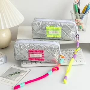 Detail view of quilted metallic silver pencil cases with colorful braided lanyards