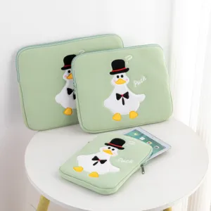Close-up of cute cartoon duck embroidery on light green protective tablet sleeve bag