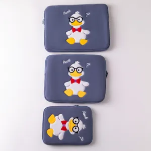 Detailed view of three grey-blue tablet sleeves with cute embroidered cartoon duck design