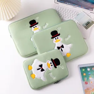 Close-up detail of high-quality cartoon duck embroidery on a sage green padded iPad sleeve