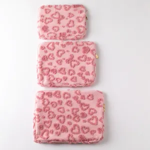 Set of three pink fuzzy laptop sleeves with embossed heart patterns for iPad and Pro