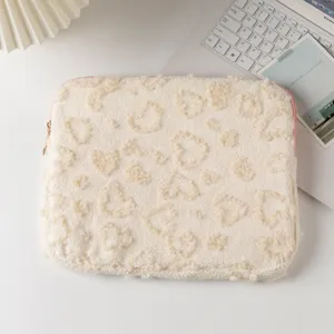 Detailed view of cream plush laptop sleeve with soft heart-shaped textured pattern