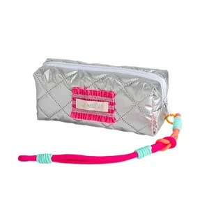 Silver quilted pencil case with colorful braided lanyard and pink accent