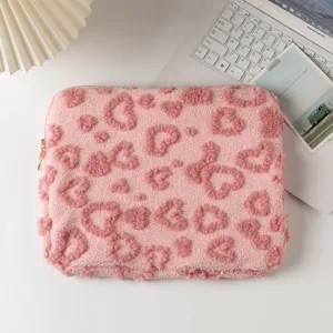 Top view of pink plush laptop sleeve with heart patterns on a white desk setup