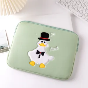 Close-up of green iPad sleeve featuring a cute embroidered duck design and Puck text