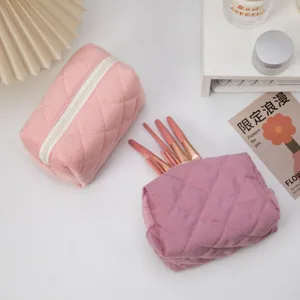 Detailed view of quilted corduroy cosmetic bags showing texture and storage capacity