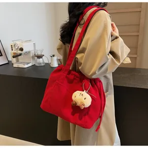 Vintage corduroy shoulder bag for women, casual large capacity tote bag with cute plush pendant.