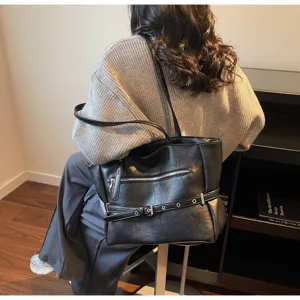 Model carrying a black retro soft leather large capacity tote bag