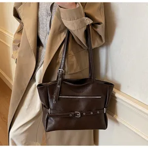 Vintage dark brown soft leather tote bag carried over the shoulder in a lifestyle shot