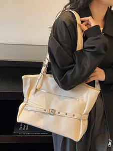 Vintage cream soft leather commuter tote bag featuring decorative belt and front zipper