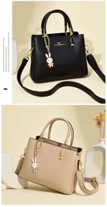 Elegant black and beige leather handbags with cute bunny bag charm and gold hardware