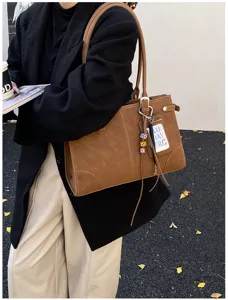 Vintage brown large capacity tote bag shown in a commuter street style outfit