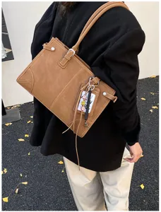 Side view of a vintage large-capacity brown tote bag with elegant stitching details