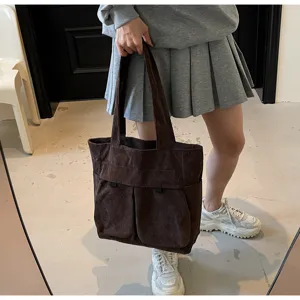 Brown corduroy tote bag detail showing large capacity multi compartment design style.