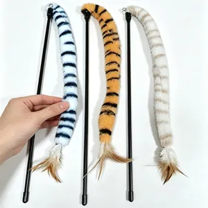 Detail view of plush tiger-striped cat teaser wands with feathers and soft texture.