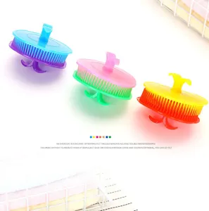 Detail view of colorful silicone pet bathing massage brushes with ergonomic handles