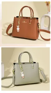 Elegance handheld bag with rabbit charm and adjustable shoulder strap in brown and sage