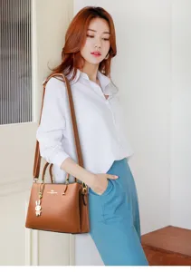 Elegant brown faux leather top-handle bag for women featuring a cute rabbit charm pendant.