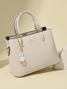 Elegant beige leather handbag with kangaroo logo and cute bunny charm pendant for women