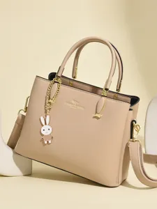 Elegant beige leather handbag for women with top handle and cute rabbit charm decoration