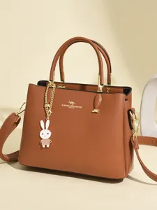 Elegant brown textured leather handbag for women with cute rabbit charm and top handle strap