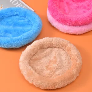Macro view of plush round beds in blue and pink for hamsters and rabbits