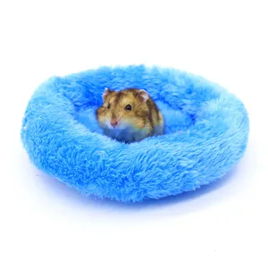 Macro view of a cozy blue plush pet bed designed for winter warmth with a small hamster