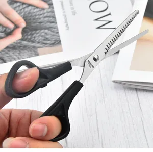 Close-up of professional stainless steel thinning shears with ergonomic black handles