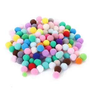 Close-up of multi-colored plush pom-poms for pet cat toys on a white background