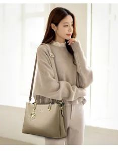 Elegant women's soft leather shoulder bag, stylish handbag with floral charm for daily wear.